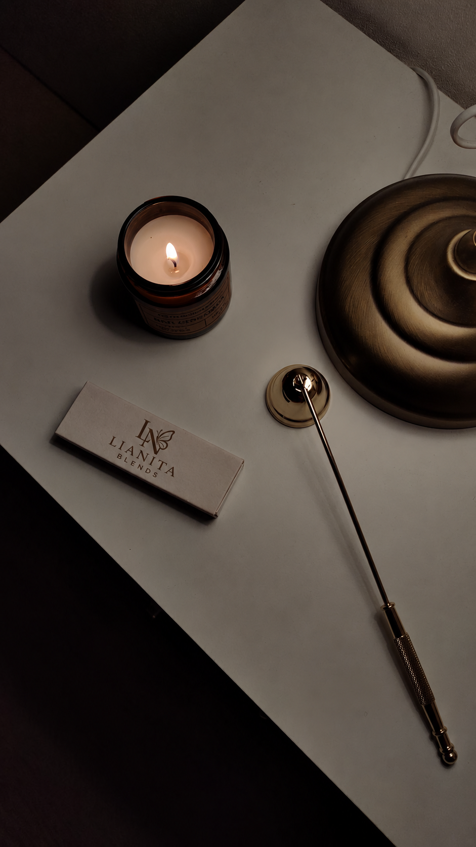 A candle with Lianita Blends branded matches