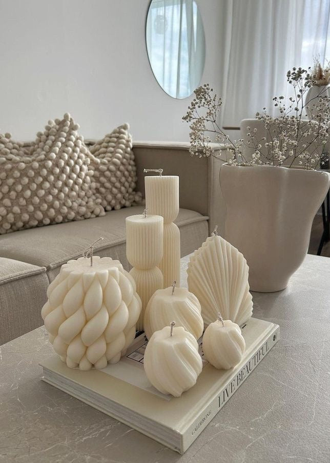 Ivory sculptural candles styled in a luxurious home